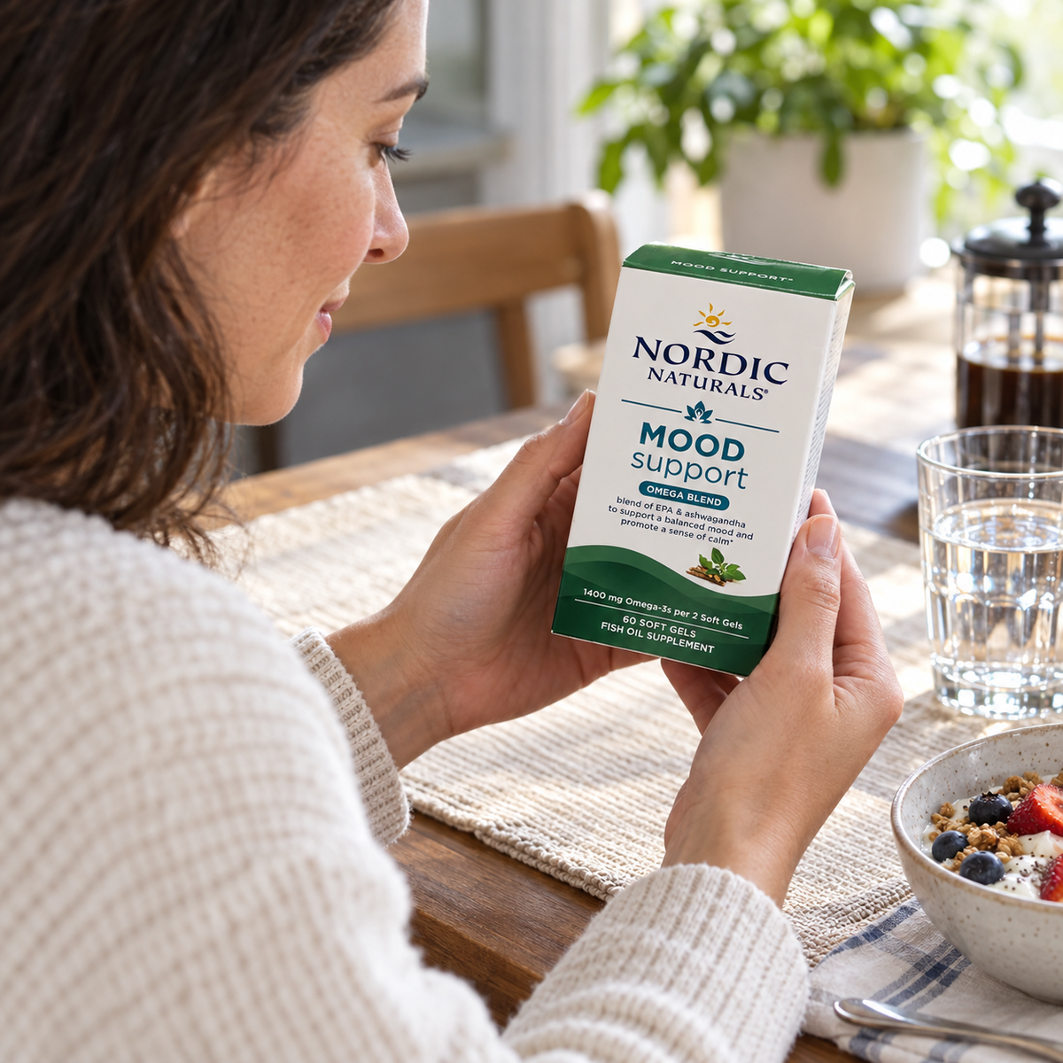 Checking a Nordic Naturals Mood Support carton before a morning supplement routine