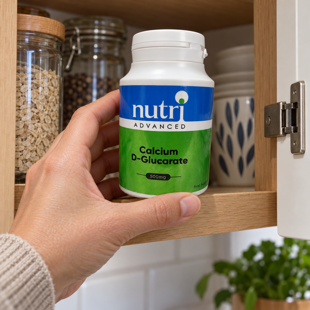 Adult retrieving Nutri Advanced Calcium D-Glucarate from a cupboard