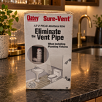 AI-styled illustrative wet-bar scene with Oatey Sure-Vent 39016 retail box; contents not shown