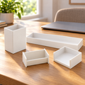 Four white Officemate desk organizers arranged on a home-office desk