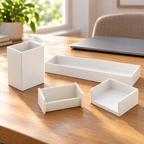 Four white Officemate desk organizers arranged on a home-office desk