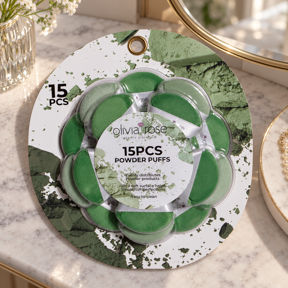 AI-generated lifestyle scene of the closed Olivia Rose green 15-piece powder puff package in a vanity table setting. Props not included.
