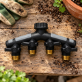 Orbit Pro Flo four-port hose manifold on an outdoor potting bench