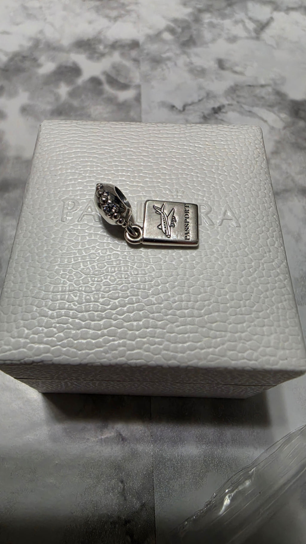 Actual Pandora Passport Travel Dangle Charm on its white box