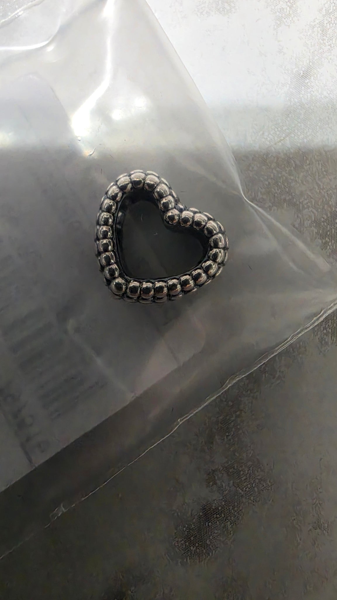 Actual close-up of the Pandora beaded open heart charm