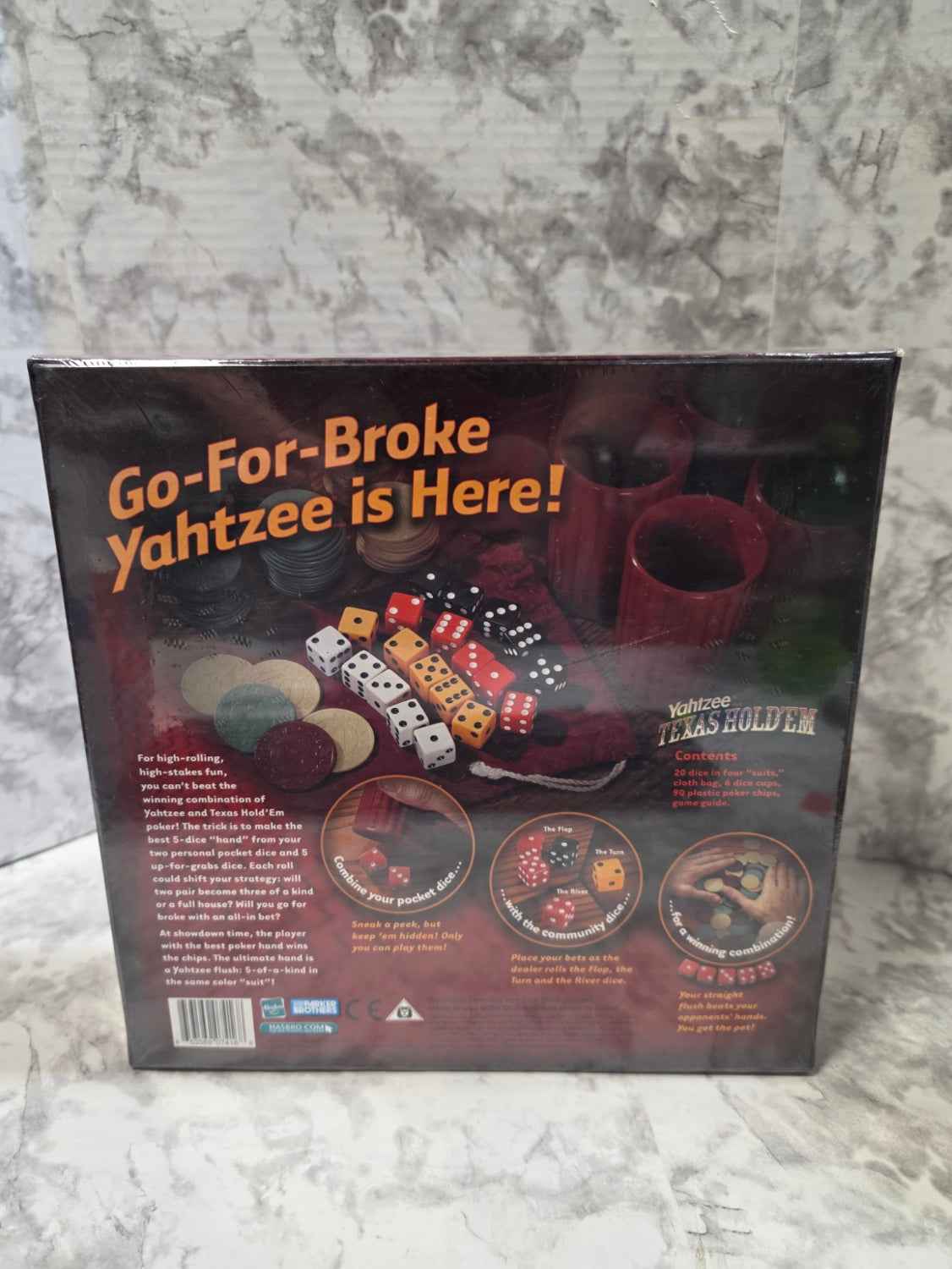 Actual stocked Parker Brothers Yahtzee Texas Hold'em dice game, item 42641, sealed box back showing contents and gameplay
