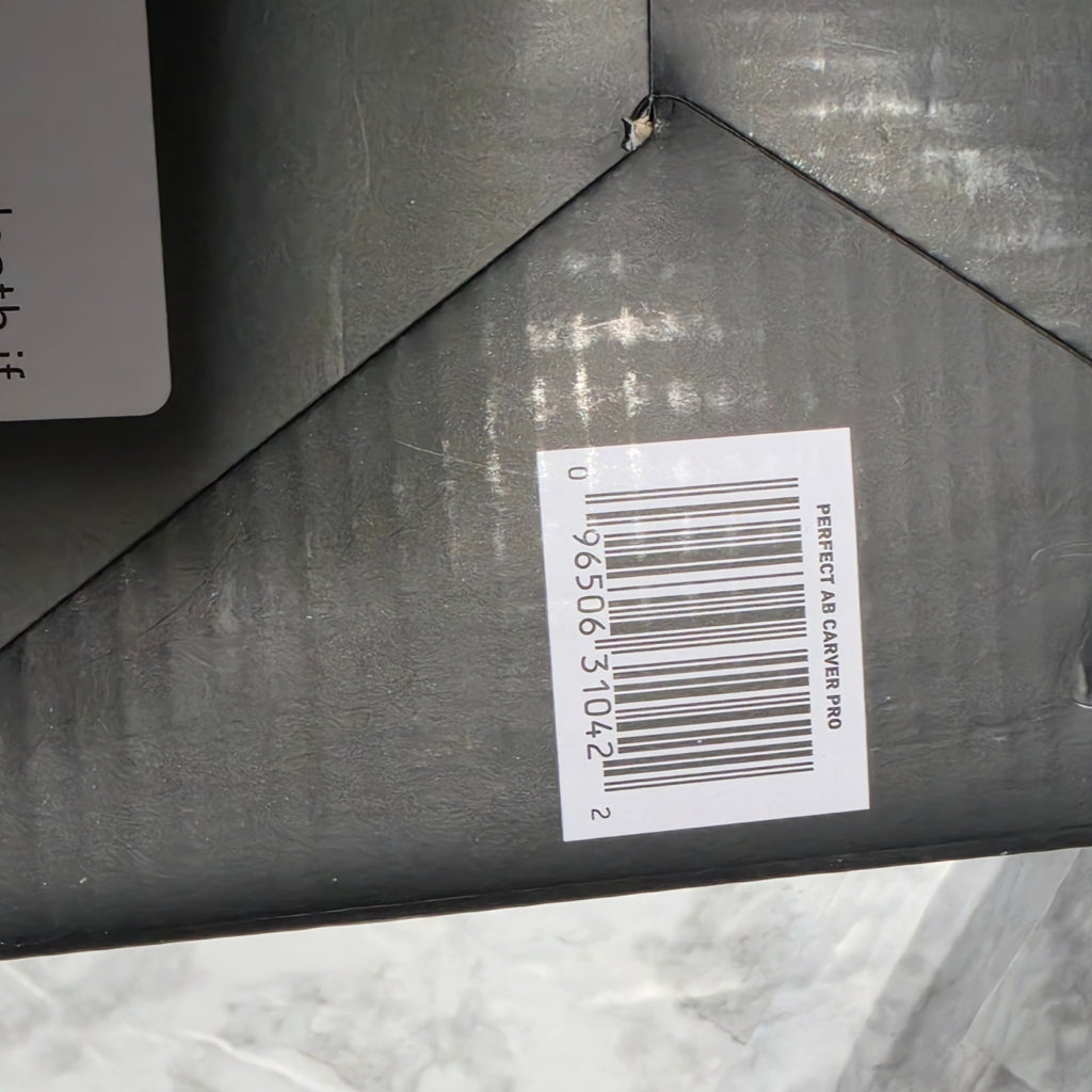 Original photograph of actual Ab Carver Pro box bottom with UPC 096506310422 and small puncture