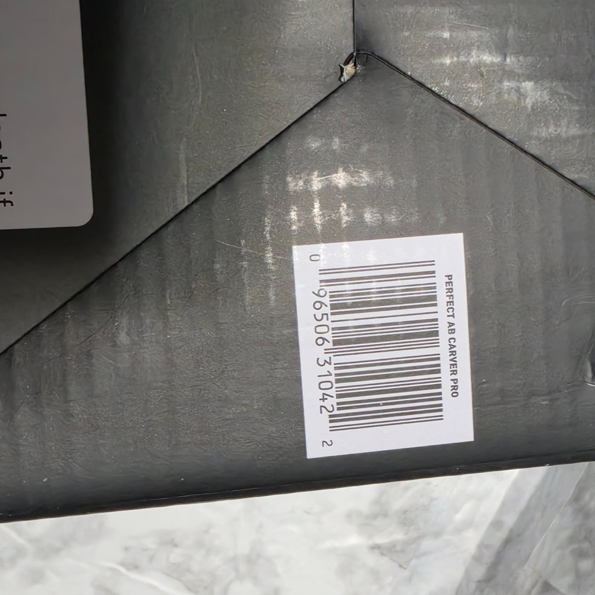 Original photograph of actual Ab Carver Pro box bottom with UPC 096506310422 and small puncture
