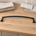 Pfister Rhen matte black towel bar resting on a wood bathroom project counter