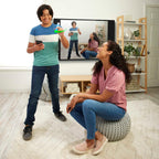 Pictionary Air 2 gameplay demonstration with a blue light pen and smartphone while the scene appears on a television.