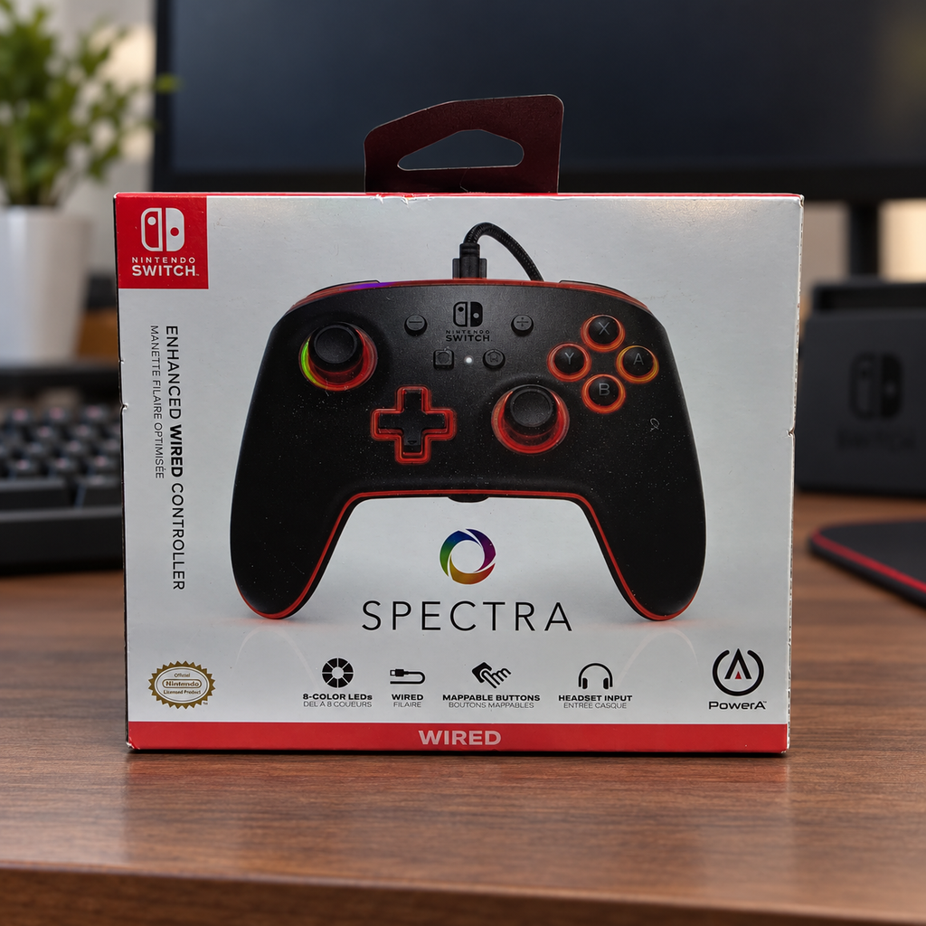 AI-generated lifestyle scene of one closed PowerA Spectra Nintendo Switch wired controller retail box in a gaming desk setting. Props not included.
