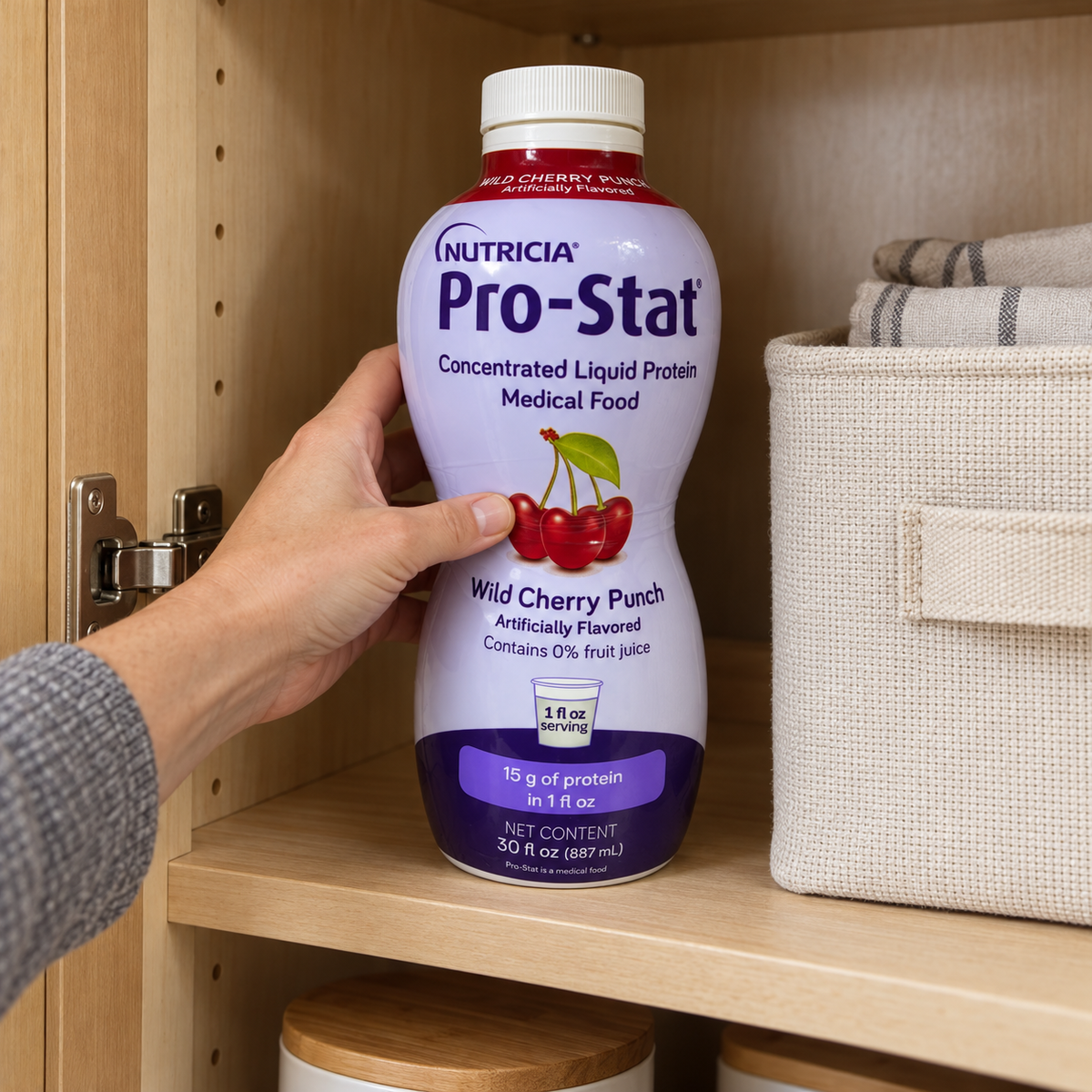 An adult placing a closed Pro-Stat Wild Cherry Punch 30-fl-oz bottle in a dry cupboard