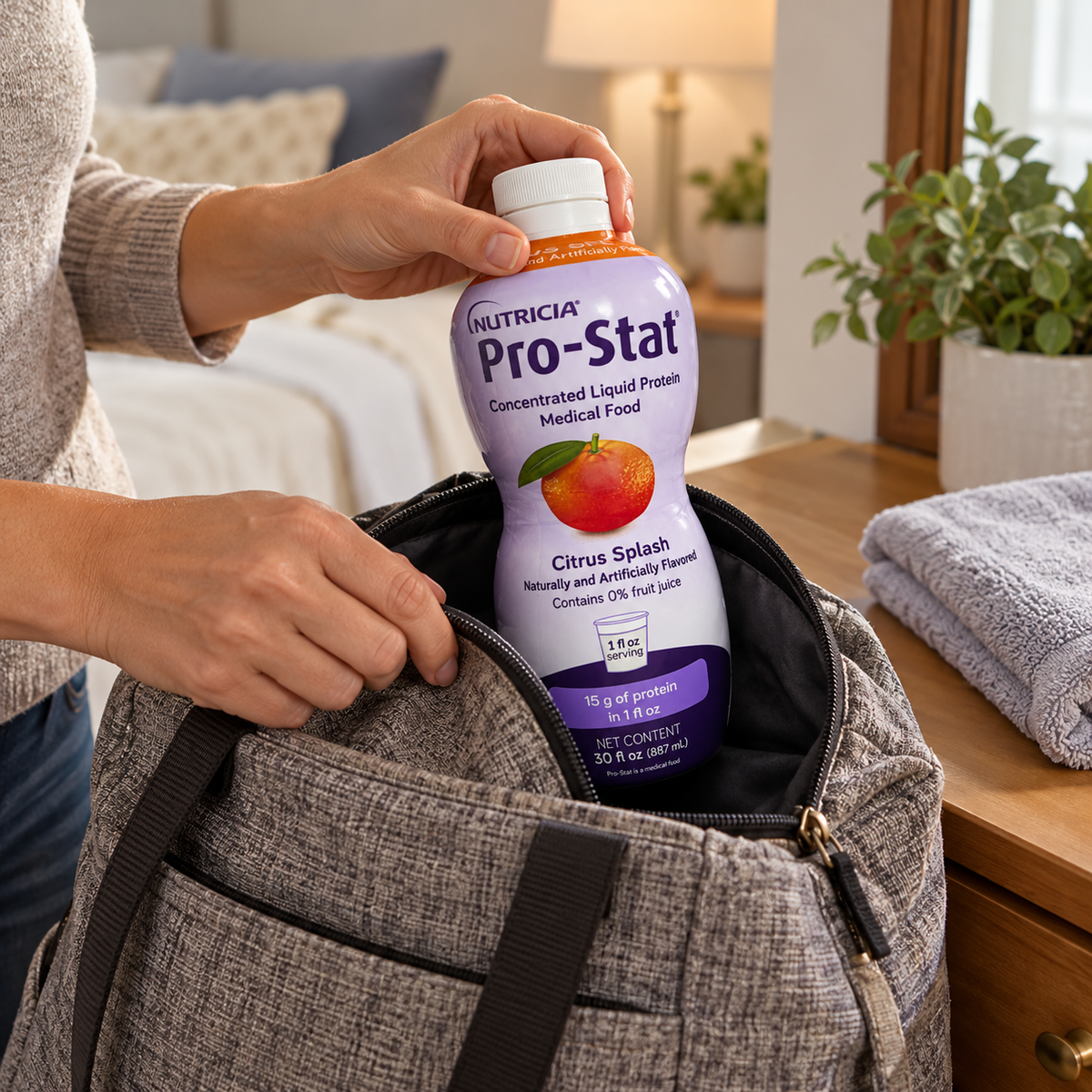 A capped Pro-Stat Citrus Splash bottle being packed in a fabric day bag