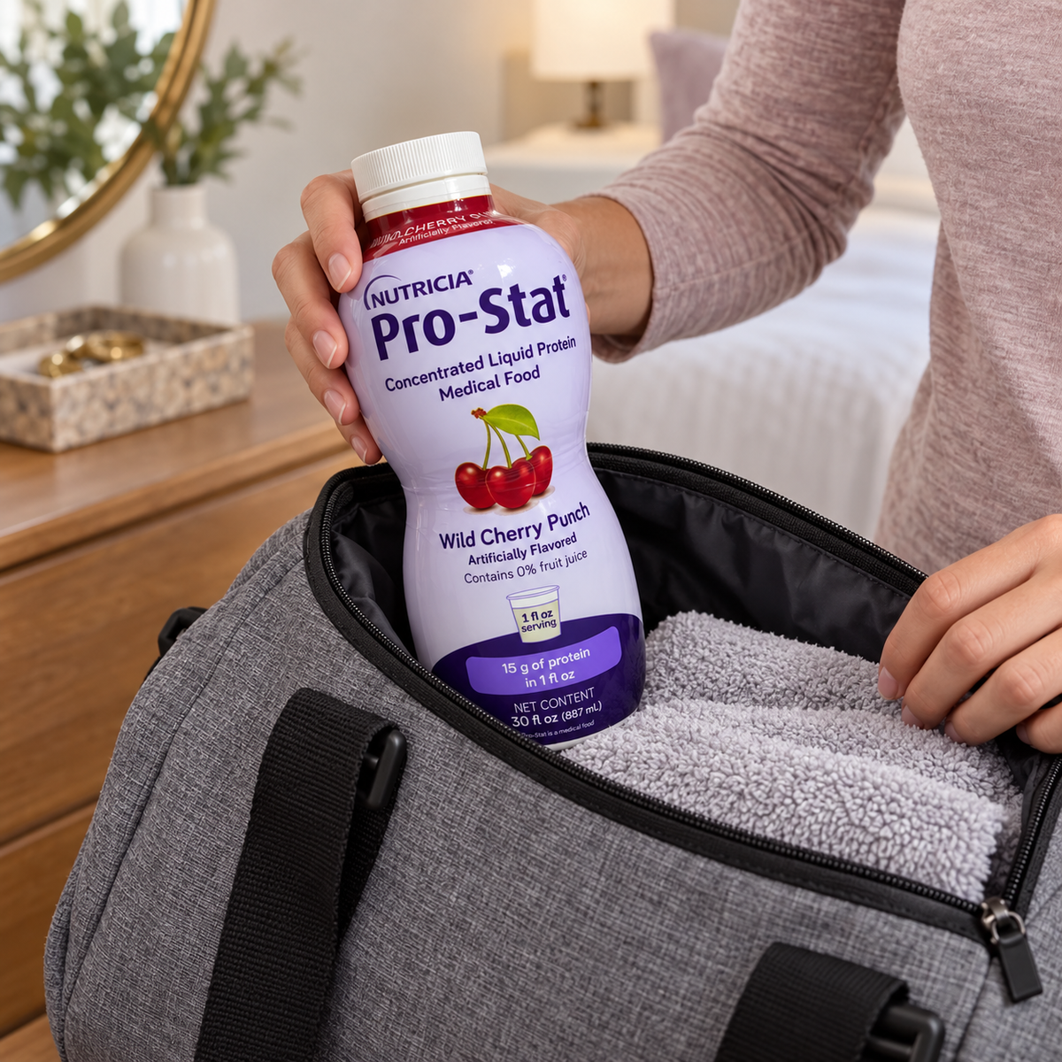 A capped Pro-Stat Wild Cherry Punch bottle being packed in a fabric day bag