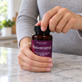 Adult twisting open a Reserveage Beauty Resveratrol 500 mg bottle.