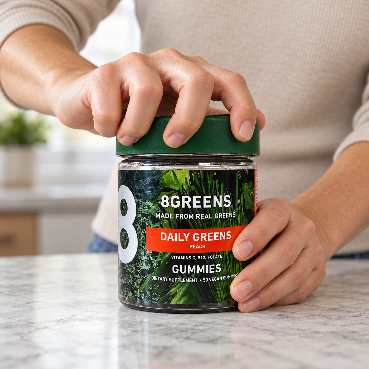 An adult beginning to unscrew the green cap of an 8Greens Daily Greens Peach 50 Vegan Gummies container.