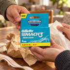 Adults handing over one Gillette Mach3 Fresh Clean 4-count refill pack with gift wrapping.