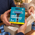 Holding one Gillette Mach3 Original eight-refill carton beside a gift bag