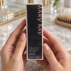 Holding the boxed Mary Kay Reviving Facial Spray beside a vanity
