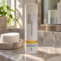 Capped Rodan + Fields REVERSE toner bottle beside cotton pads on a bathroom counter