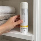 Placing the capped Rodan + Fields REVERSE toner bottle on a bathroom cabinet shelf
