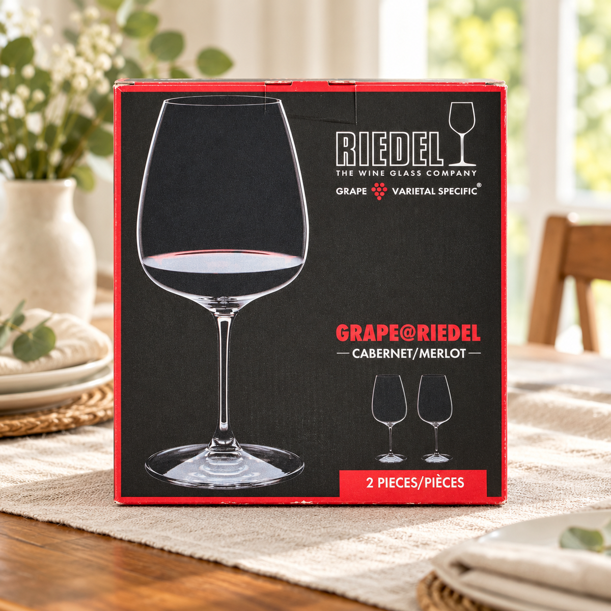 AI-generated lifestyle scene of one closed GRAPE@RIEDEL Cabernet/Merlot two-piece glass box in a dining table setting. Props not included.