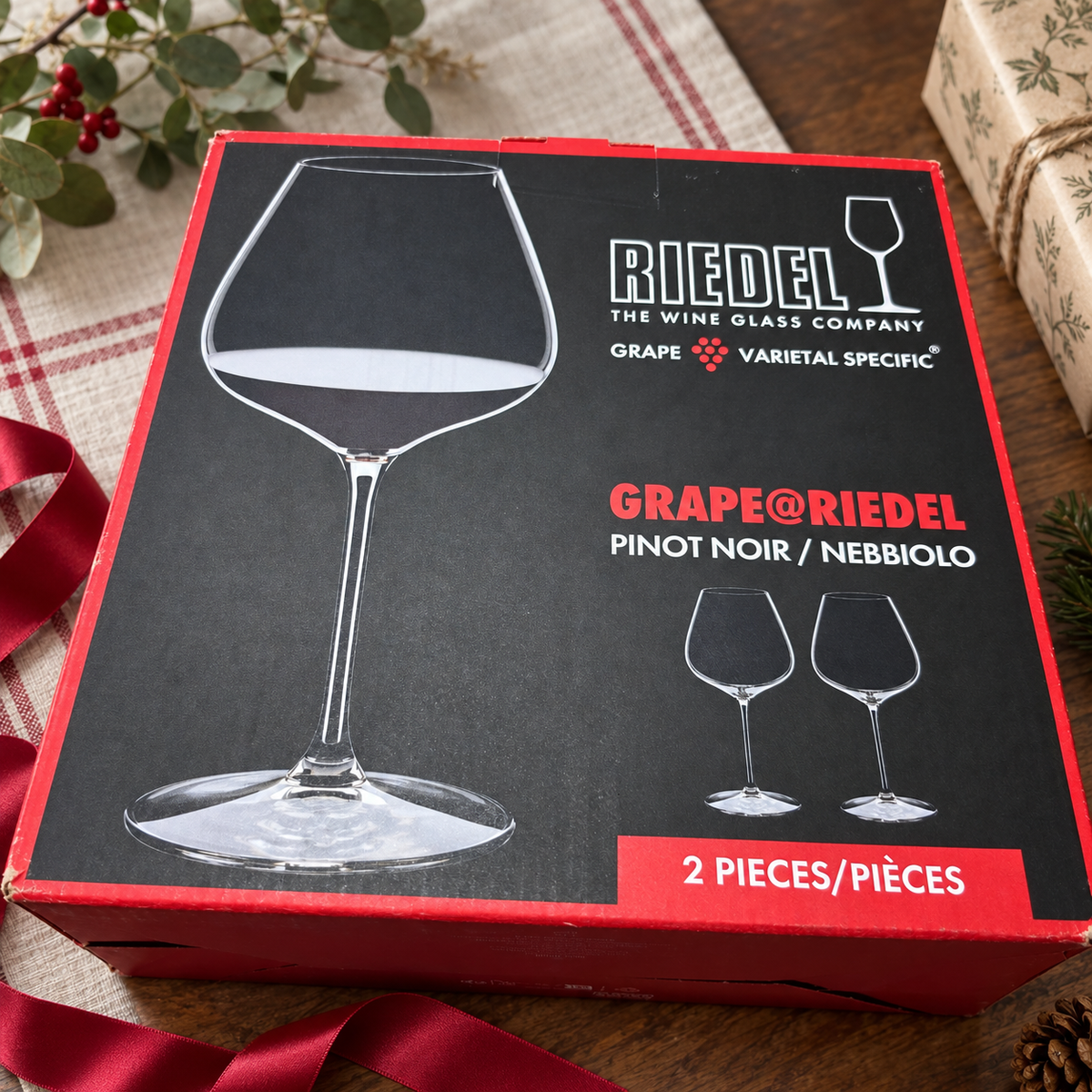 AI-generated lifestyle scene of one closed GRAPE@RIEDEL Pinot Noir Nebbiolo two-piece box on a gift table. Props not included.