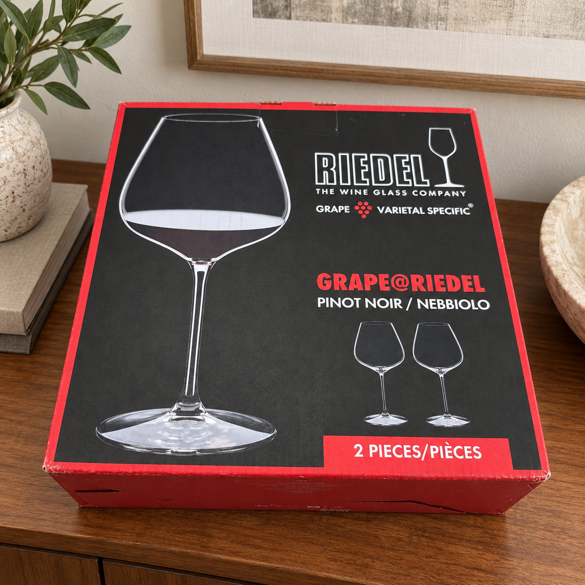 AI-generated lifestyle scene of one closed GRAPE@RIEDEL Pinot Noir Nebbiolo two-piece box on a sideboard. Props not included.