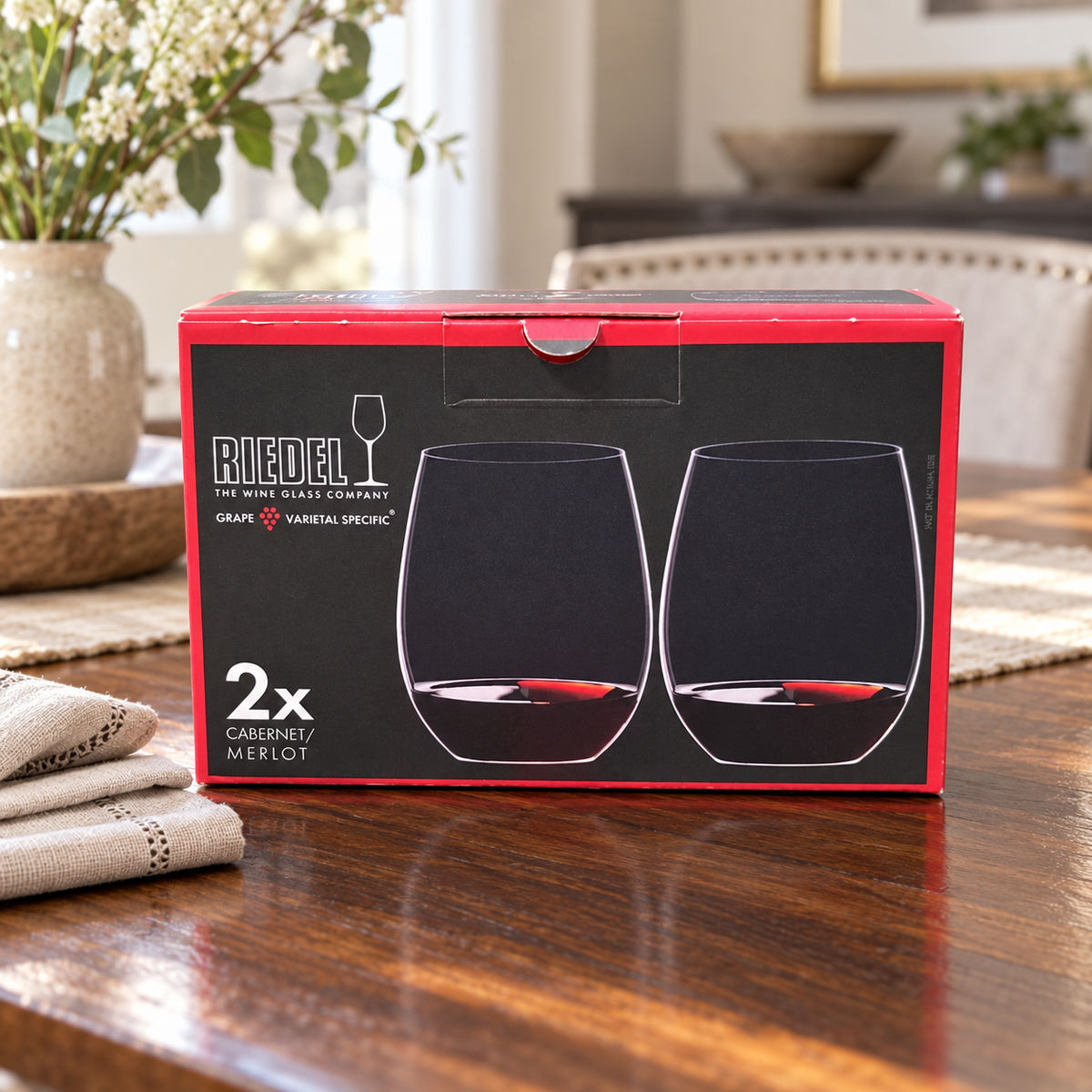 AI-generated lifestyle illustration of one closed RIEDEL O Cabernet/Merlot two-piece box in a dining table setting. Background props not included.