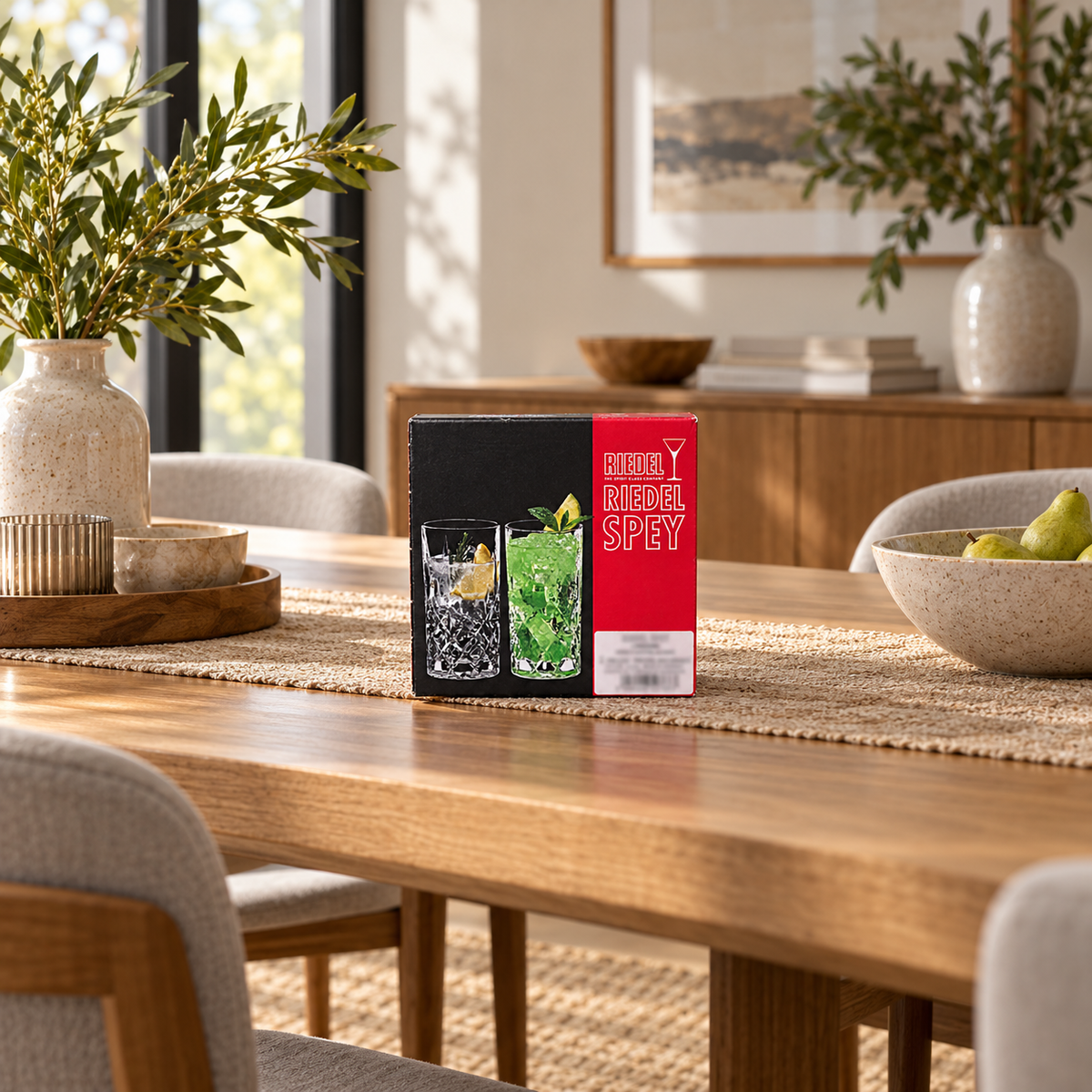 AI-generated lifestyle scene of one closed Riedel Spey Longdrink two-piece glass box on a dining table. Props not included.