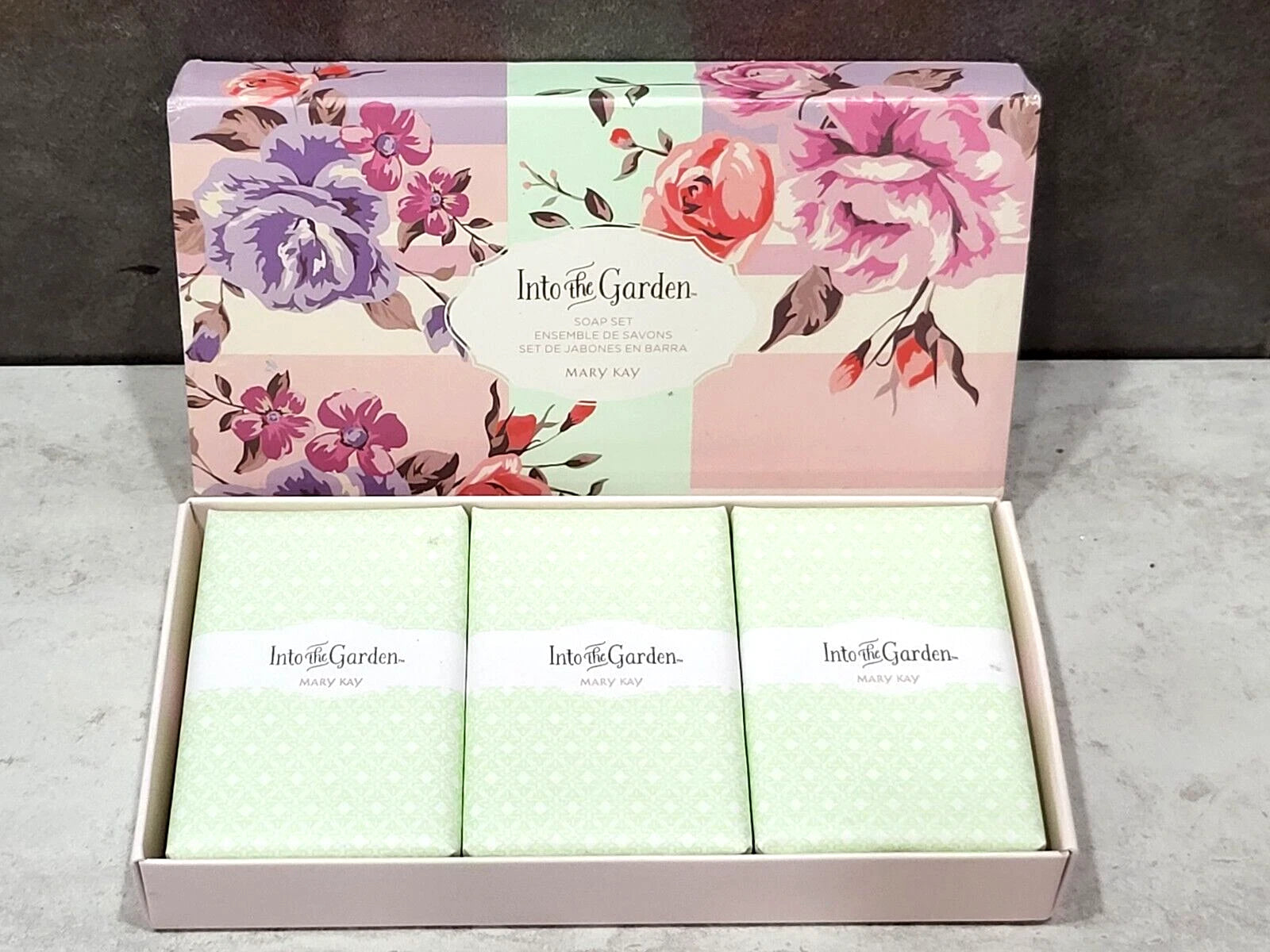 Floral-themed product packaging with 'Into the Garden' branding on a neutral background