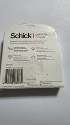 Back of the actual Schick Quattro Titanium six-cartridge box, with UPC 841058082484, product features, packaging scuffs and sticker residue