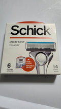 Actual stocked box of Schick Quattro Titanium razor blade refills, six cartridges, showing the front packaging and light edge wear