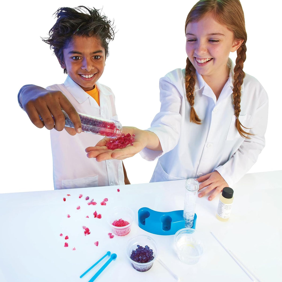 Children handling colorful jiggly crystals with the Scientific Explorer test tubes, stand and plastic cups.