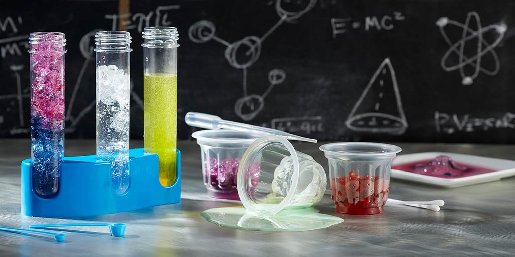 Scientific Explorer test tubes, stand, cups and tools with colorful experiment materials on a tabletop.