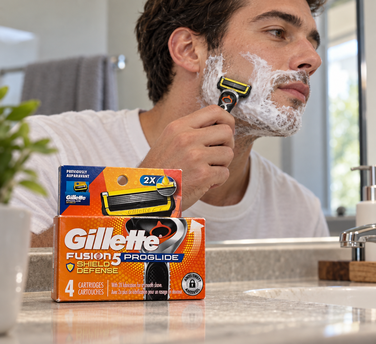 Gillette Fusion5 ProGlide Shield refills beside a sink during an adult's shaving routine.