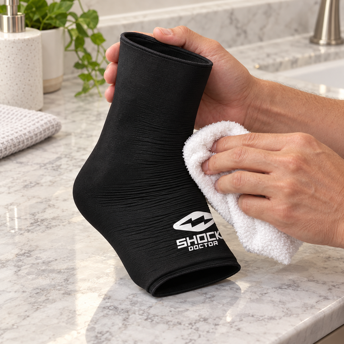 Wiping a Shock Doctor Flex Ice ankle sleeve with a damp cloth