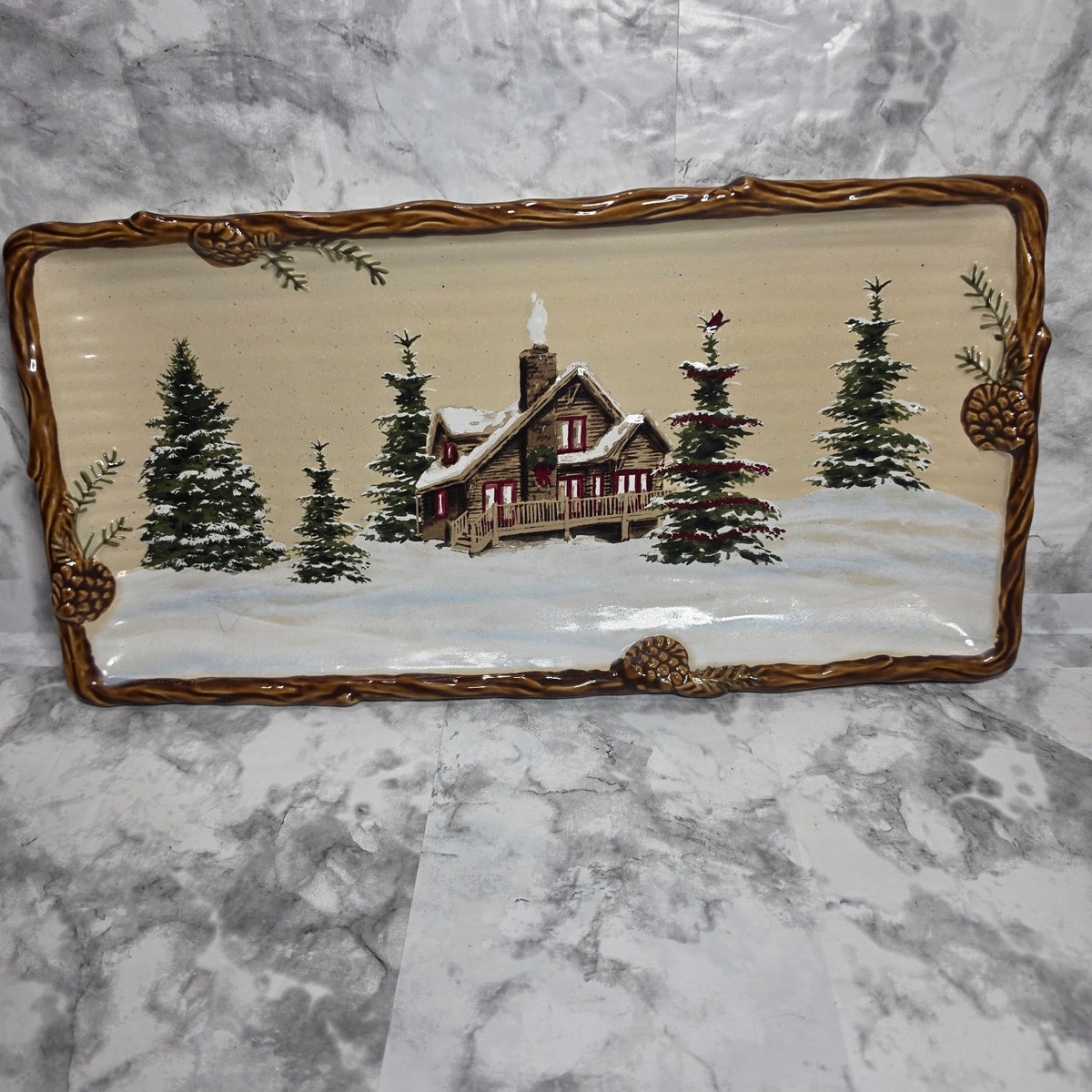 St. Nicholas Square Snow Valley rectangular platter with snowy cabin and raised brown pinecone border