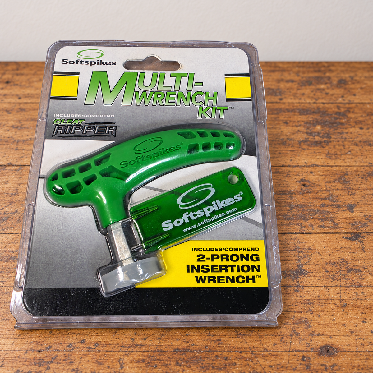 AI-generated lifestyle scene of one closed Softspikes Multi-Wrench Kit package on an empty wood workbench. No other items included.