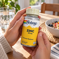 Holding Solaray Zinc 50 mg beside breakfast