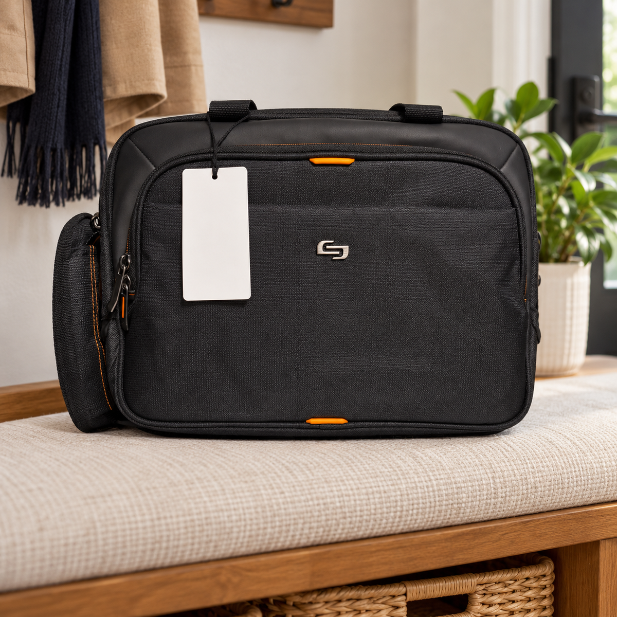 AI-generated lifestyle scene of the closed black Solo New York Ace briefcase with orange accents in a travel bench setting. Props not included; tag shown from reverse.