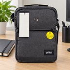 AI-generated lifestyle scene of the closed gray Solo New York Ludlow tablet sling on an office desk. Props not included; hangtag shown from reverse.