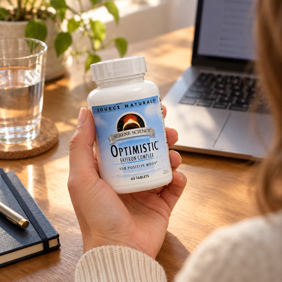 Source Naturals Optimistic bottle held during a home-office break