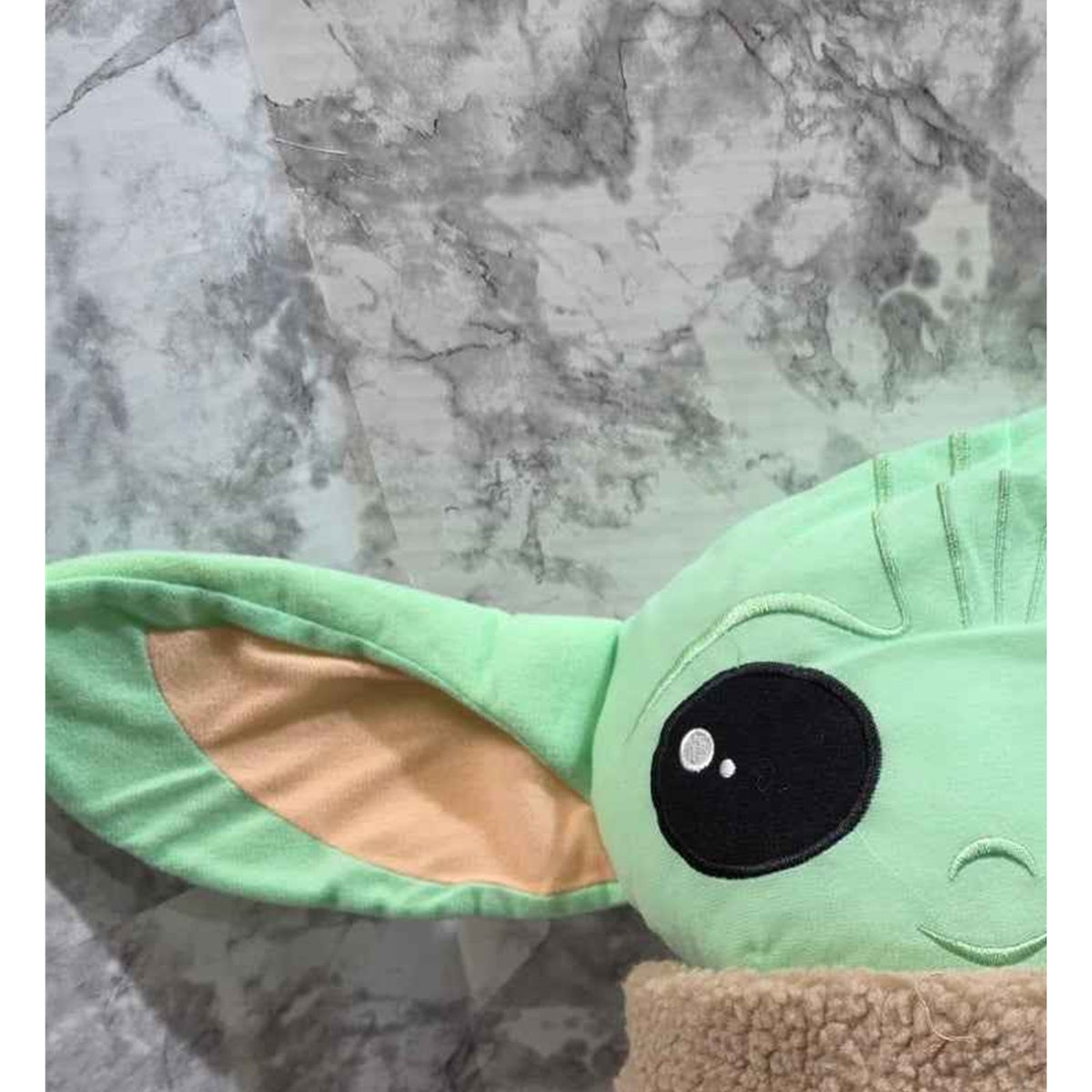 Actual photo detail of Star Wars Grogu plush side ear and soft fabric construction