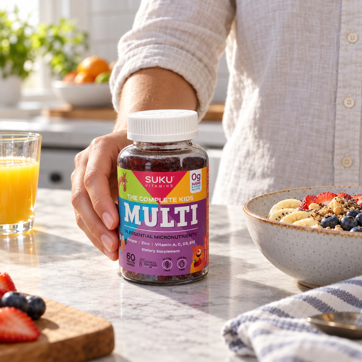 Adult placing SUKU Kids Multi bottle beside breakfast