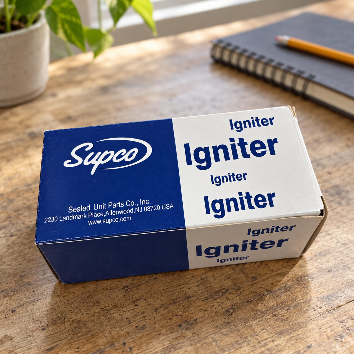 Supco igniter box beside a notebook in a planning workspace