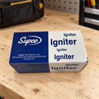 Supco igniter box on a workshop bench with a tool bag in the background