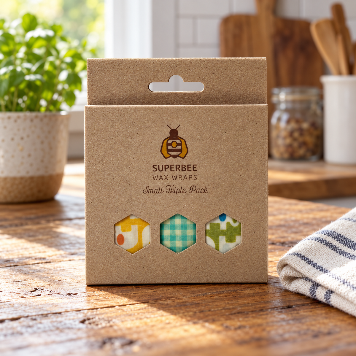 AI-generated lifestyle illustration of one closed SuperBee Small Triple Pack wax wrap package in a kitchen table setting. Background props not included.