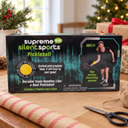AI-generated lifestyle illustration of one closed Supreme Silent Sports Pickleball set box in a gift table setting. Background props not included.