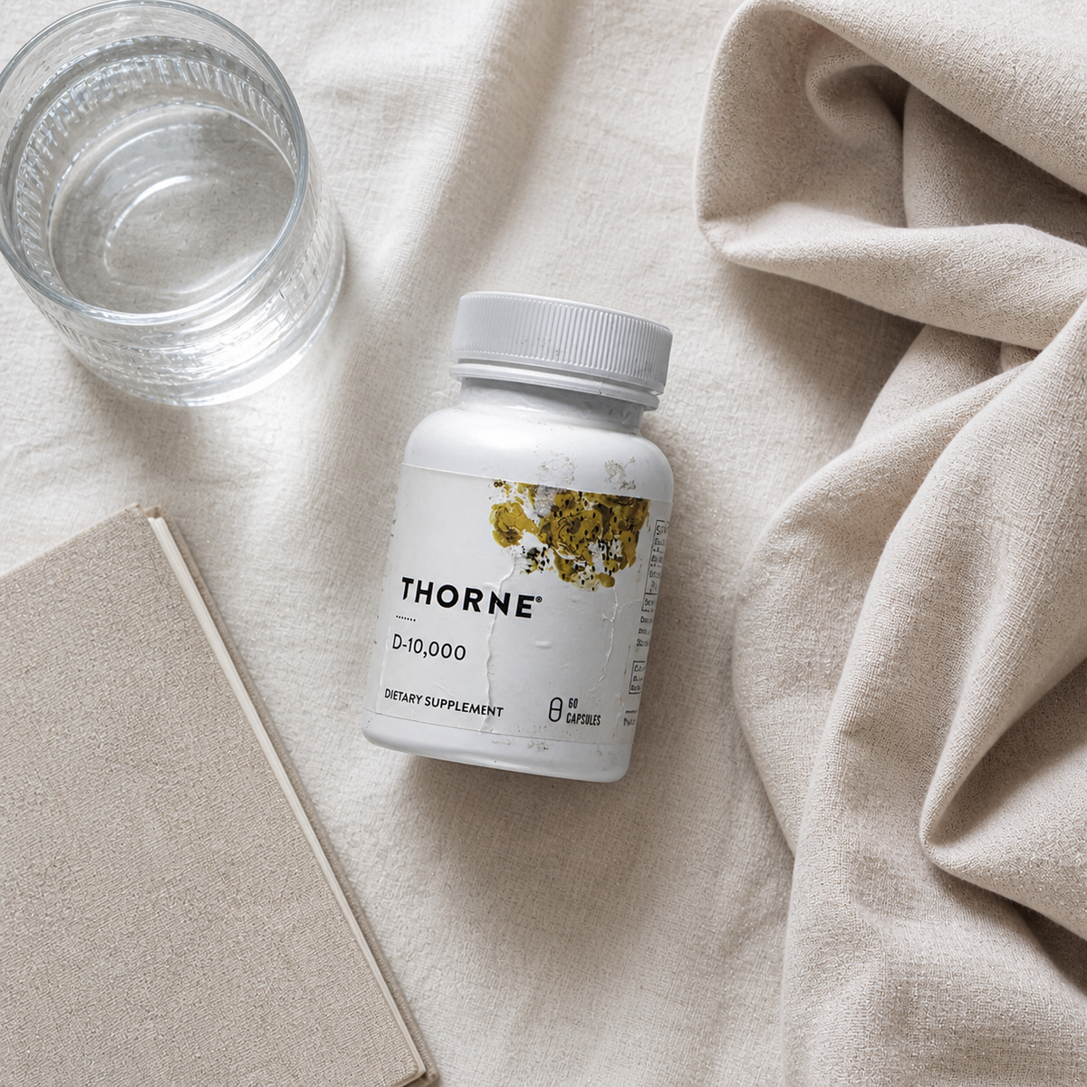 Thorne D-10,000 bottle in a neutral wellness flat lay – AI lifestyle image